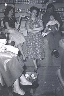 From left: my sister, Rose, my Aunt Doris, her husband, Uncle Bennie, holding my cousin, Lona.   Sadly, all now deceased. To the far left, you can see the butcher paper holder circa 1954